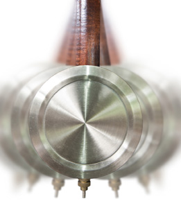 This is a photo of a traditional pendulum clock in motion.