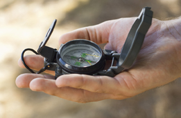 This is a photo of a hand holding a compass.