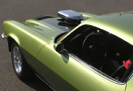 This photo shows a green drag racing car.