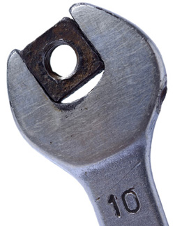 This picture shows a wrench on a nut.