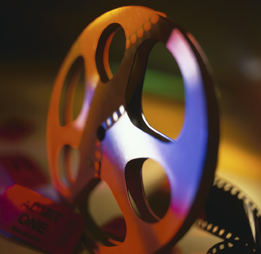 This is a photo of a film reel and a movie ticket.