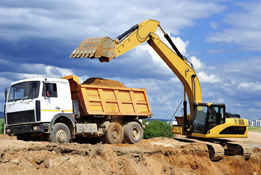 This photo is of a gravel truck and loader.