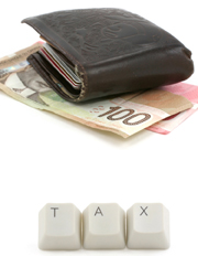 This is a photo of a wallet on top of a 100 dollar bill. Lower in the photo are three keys from a keyboard that spell out the word “tax.” 