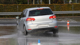 This photo shows a car stopping in the rain.