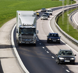 In this photo a delivery truck is part of the busy traffic on a freeway.