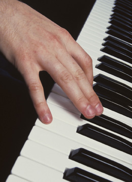 This is a photo of a hand playing the piano.