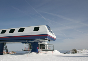 A photograph shows the terminal of a high-speed chairlift.
