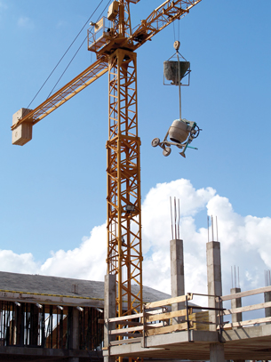 A crane lifts objects at a construction site in this photograph.