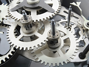 A photograph shows the gears from inside a clock.