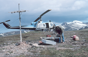This is a photograph of a chopper delivering a seismic crew to a remote location.