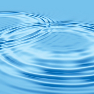A photograph shows two ripples on a water surface. The waves from the two ripples are meeting and combining.